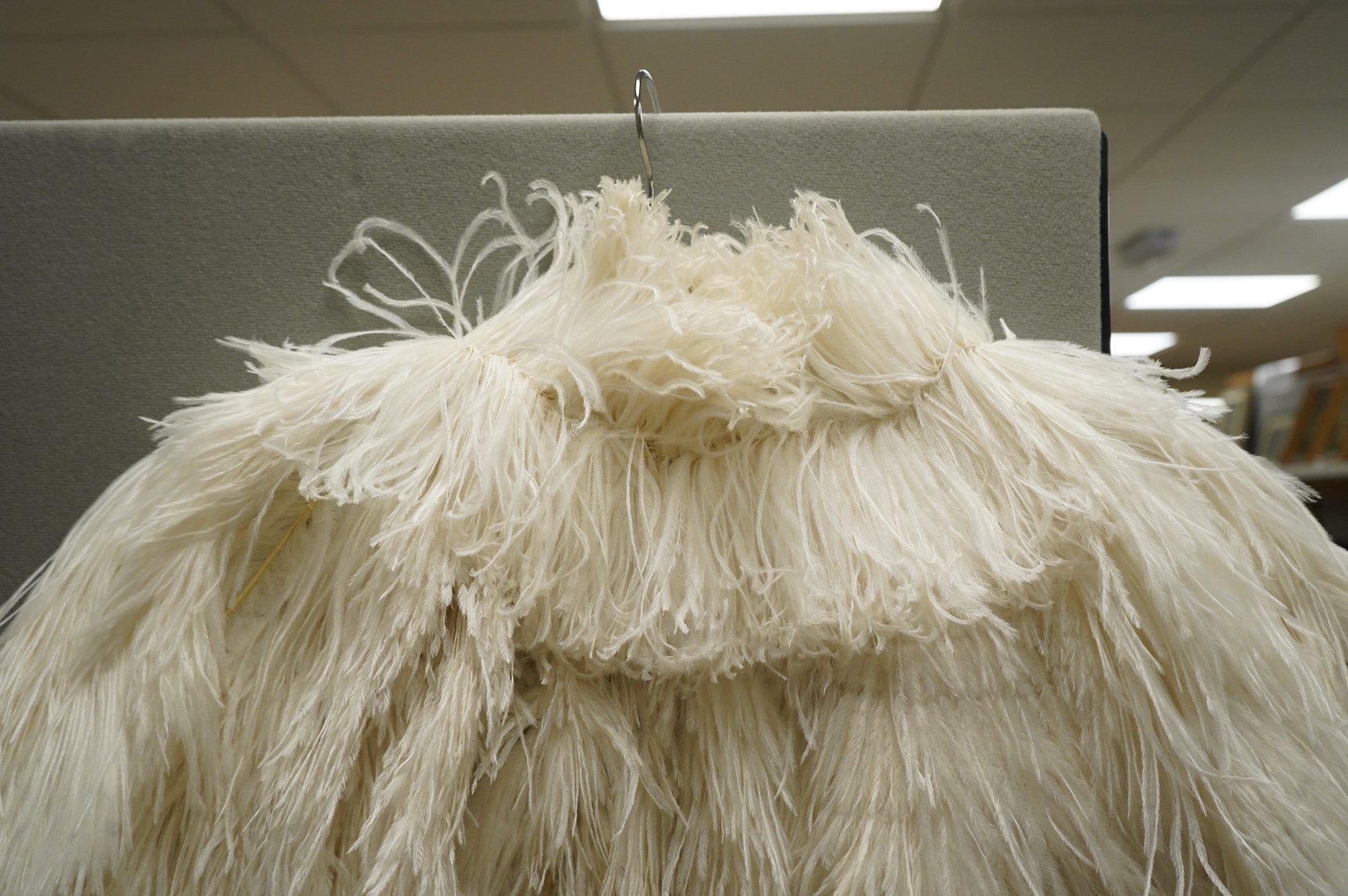 A 1930’s white Ostrich feather evening cape, with small feather stand up collar half lined in georgette.667cm long from top of collar to base. Condition - good - may need professional cleaning.